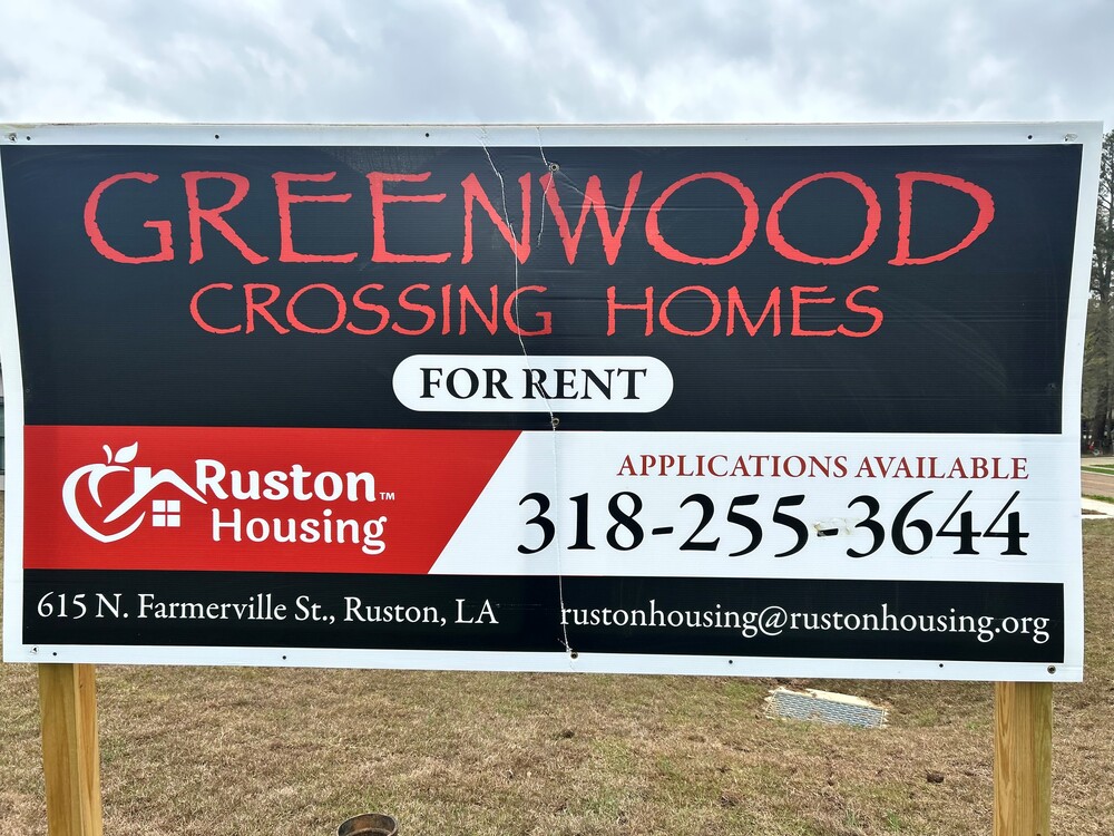 Greenwood Crossing Homes sign with contact information on it. Ruston Housing. 615 N. Farmerville St. Ruston, LA. Applications Available 318-255-3644. Rustonhousing@rustonhousing.org.